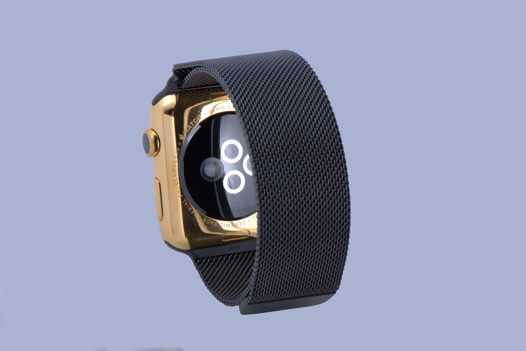 Gold watch case with a black Milanese band